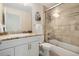 Bathroom featuring a glass shower door, stone vanity, white cabinets, and modern fixtures at 1551 S Grant St, Denver, CO 80210