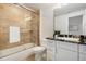 Bathroom featuring stone tile in the shower, a glass shower door, and a granite countertop at 1551 S Grant St, Denver, CO 80210