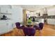 Charming dining area featuring a round table with purple chairs, hardwood floors, and stylish decor at 1551 S Grant St, Denver, CO 80210