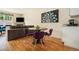 Cozy dining area features hardwood floors, a modern table with purple chairs, stylish lighting, and easy access to the living area at 1551 S Grant St, Denver, CO 80210