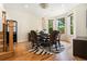 Inviting dining room with hardwood floors, an elegant chandelier, and large windows with natural light and backyard views at 1551 S Grant St, Denver, CO 80210