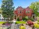 Stunning red brick home features a manicured lawn and beautiful landscaping, providing inviting curb appeal at 1551 S Grant St, Denver, CO 80210