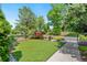 Manicured front yard with artificial turf, attractive landscaping, and an ornamental fence creating a welcoming outdoor space at 1551 S Grant St, Denver, CO 80210