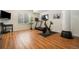 Home gym featuring updated laminate flooring, a treadmill, exercise bike, and TV at 1551 S Grant St, Denver, CO 80210