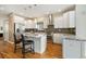 Bright, open kitchen with white cabinets, granite countertops, stainless steel appliances, and a convenient kitchen island at 1551 S Grant St, Denver, CO 80210