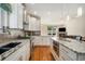 Contemporary kitchen featuring white cabinetry, granite countertops, stainless steel appliances and hardwood floors at 1551 S Grant St, Denver, CO 80210