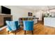 Spacious living room featuring hardwood floors, a fireplace, and an open layout into the kitchen at 1551 S Grant St, Denver, CO 80210