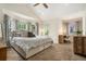 Bright and airy main bedroom featuring a large bed, access to balcony, and ample natural light at 1551 S Grant St, Denver, CO 80210