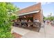 Inviting outdoor dining area with a brick facade and retractable awning at 1551 S Grant St, Denver, CO 80210