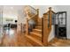 View of the wood staircase with black metal railings and a hardwood floor leading into the main living area at 1551 S Grant St, Denver, CO 80210