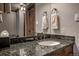 Modern bathroom with granite countertop, decorative towels, and ample lighting for a clean and elegant space at 107 Ski Watch Rd # 32, Breckenridge, CO 80424