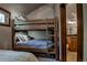 Bedroom features a rustic bunk bed, with cozy quilts, and ensuite bathroom at 107 Ski Watch Rd # 32, Breckenridge, CO 80424