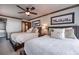 Charming bedroom with two beds, decorative pillows, and a ceiling fan for a cozy and inviting ambiance at 107 Ski Watch Rd # 32, Breckenridge, CO 80424
