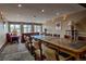 A spacious dining room with a long table, chairs, and scenic views from the windows at 107 Ski Watch Rd # 32, Breckenridge, CO 80424