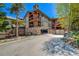 Charming condo building with multi-level balconies, stone accents, and a private driveway at 107 Ski Watch Rd # 32, Breckenridge, CO 80424