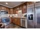 Well-equipped kitchen featuring wooden cabinetry, stainless steel appliances and tile backsplash at 107 Ski Watch Rd # 32, Breckenridge, CO 80424