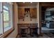 Compact kitchenette with a built-in bar, cabinetry, and scenic views outside the window at 107 Ski Watch Rd # 32, Breckenridge, CO 80424
