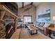 Cozy living room with a stone fireplace and a comfortable leather sofa at 107 Ski Watch Rd # 32, Breckenridge, CO 80424
