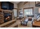 Cozy living room featuring a stone fireplace and a comfortable leather sofa at 107 Ski Watch Rd # 32, Breckenridge, CO 80424