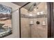Shower featuring tile walls, stylish fixtures, and built-in shelving for toiletries at 107 Ski Watch Rd # 32, Breckenridge, CO 80424