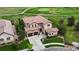 Expansive property boasts a terracotta roof, three-car garage, manicured lawn, and is located on a golf course at 16491 Fairway Dr, Commerce City, CO 80022