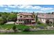 Expansive backyard features a sport court, outdoor seating, lush landscaping, and an in-ground trampoline at 16491 Fairway Dr, Commerce City, CO 80022