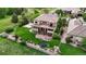 This backyard has a sports court, covered patio, fire pit, in-ground trampoline, and a meticulously kept lawn at 16491 Fairway Dr, Commerce City, CO 80022