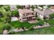 Large backyard features a sports court, covered patio, fire pit, in-ground trampoline, and a lush lawn at 16491 Fairway Dr, Commerce City, CO 80022