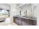 Modern bathroom boasts dual sinks, granite counters, and decorative backsplash at 16491 Fairway Dr, Commerce City, CO 80022