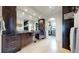 Luxurious bathroom boasting double sinks, modern cabinetry, tiled accents, and a walk-in closet at 16491 Fairway Dr, Commerce City, CO 80022