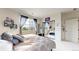 Bright bedroom featuring a large window, mirrored closet, and neutral decor at 16491 Fairway Dr, Commerce City, CO 80022