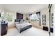 Spacious bedroom with large windows, carpet, and a comfortable queen bed at 16491 Fairway Dr, Commerce City, CO 80022