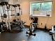 This in home gym features a variety of equipment, including a universal weight machine and stationary bike at 16491 Fairway Dr, Commerce City, CO 80022