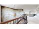Second floor hallway features an ornate railing, decorative lighting, art on the walls, and views of the home's interior at 16491 Fairway Dr, Commerce City, CO 80022