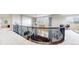 Upstairs hallway overlooking the living area showcasing an ornate railing, and access to multiple rooms at 16491 Fairway Dr, Commerce City, CO 80022