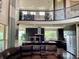 Open-concept kitchen with a large island, modern appliances, and view to the upper level with wrought iron railings at 16491 Fairway Dr, Commerce City, CO 80022