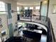Open-concept living space with soaring ceilings, a wrought iron railing, and ample natural light at 16491 Fairway Dr, Commerce City, CO 80022