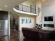 Open concept living room with fireplace, large windows, and hardwood floors showcases an elegant design at 16491 Fairway Dr, Commerce City, CO 80022