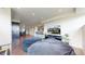 Open living area with dark wood floors, oversized bean bags, and recessed lighting at 16491 Fairway Dr, Commerce City, CO 80022