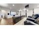Home theater with projector, screen, and comfortable seating on dark wood floors at 16491 Fairway Dr, Commerce City, CO 80022