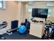 Basement gym with rubber floors, a wall-mounted television, and workout equipment at 16491 Fairway Dr, Commerce City, CO 80022