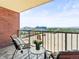 Outdoor balcony offering city views, brick accents, and seating area for relaxing at 1301 Speer Blvd # 702, Denver, CO 80204