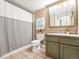 Neutral bathroom with a combination shower and tub featuring tiled floors and ample lighting at 1301 Speer Blvd # 702, Denver, CO 80204