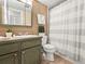 Cozy bathroom featuring tiled floors and ample storage with a sink and shower-tub combo at 1301 Speer Blvd # 702, Denver, CO 80204
