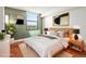 Serene bedroom with stylish decor, a large window with city views, and natural light at 1301 Speer Blvd # 702, Denver, CO 80204