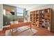 Comfortable home office featuring a desk, shelving, natural light, and hardwood floors at 1301 Speer Blvd # 702, Denver, CO 80204