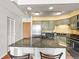 Well-lit kitchen with stainless steel appliances and a granite-topped island with seating at 1301 Speer Blvd # 702, Denver, CO 80204