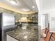 Well-equipped kitchen with granite countertops, stainless steel appliances, and ample storage space at 1301 Speer Blvd # 702, Denver, CO 80204