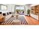 Spacious living room with hardwood floors, modern furnishings, and a balcony with city views at 1301 Speer Blvd # 702, Denver, CO 80204