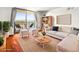 Bright living room featuring a balcony with stunning views and cozy seating arrangements at 1301 Speer Blvd # 702, Denver, CO 80204
